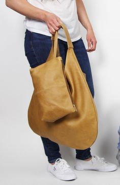 This mustard large boho bag is made from high quality italian distressed leather. Leather can have, fence and brush marks, scratch marks and even brands. Mustard shoulder bag with leather cosmetic bag. Height from top of handle to base: 66cm (26inches) Width at widest point : 49cm (19,2inches) Elegant and stylish hobo bag made from high quality leather. The hobo bag can be worn as a shoulder bag . Spacious interior provides room for all the daily essentials and more. * Different colors * Waterpr Everyday Soft Leather Hobo Pouch Bag, Everyday Soft Leather Pouch Hobo Bag, Soft Leather Hobo Bag In Pouch Shape For Everyday, Hobo Bag With Removable Pouch, Versatile Soft Leather Hobo Pouch Bag, Versatile Soft Leather Pouch Hobo Bag, Hobo Bag With Removable Pouch For Everyday Use, Versatile Soft Leather Hobo Shoulder Bag, Hobo Satchel With Removable Pouch For Daily Use