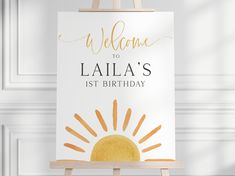 an easel with a welcome sign on it and the words,'welcome to laia's 1st birthday '