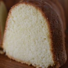 a piece of white cake sitting on top of a wooden cutting board