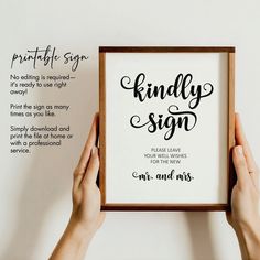 two hands holding up a framed sign that reads, find the signs