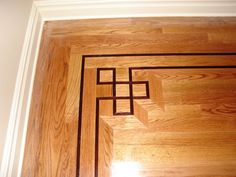 a wooden floor with an intricate design on the top and bottom part inlays