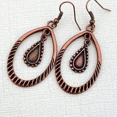 Striking statement earrings made with large, beautifully detailed copper hoops and ethnic charms  Large but lightweight earrings. Neutral colors go with any outfit. Perfect earrings for all your seasonal celebrations! Hypoallergenic ear wires (nickel and lead free). Select ear wire style at checkout.  Free gift packaging included. Earrings are carded and in an organza bag. Link to my shop: https://www.etsy.com/shop/JezaJewelry Copper Hoop Earrings - Big Boho Dangle Earrings - Statement Hoops - A Bohemian Brown Pierced Hoop Earrings, Bohemian Copper Dangle Hoop Earrings, Vintage Teardrop Hoop Earrings In Metal, Bohemian Copper Hoop Earrings, Vintage Teardrop Metal Hoop Earrings, Bronze Metal Dangle Teardrop Earrings, Bronze Metal Teardrop Dangle Earrings, Bohemian Copper Chandelier Earrings, Bohemian Copper Hoop Jewelry