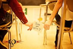 two people sitting at a table holding hands and touching each other's fingers with the words, high school sweetheart wedin