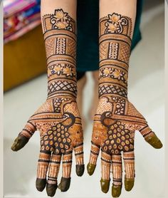 two hands with henna designs on them