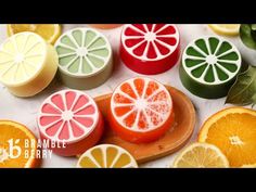 oranges, lemons and grapefruit slices are arranged on a cutting board