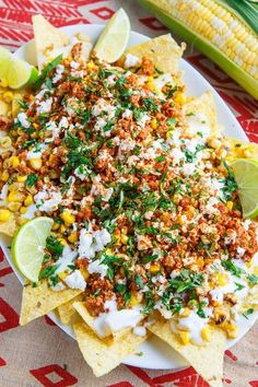 a plate filled with corn, cheese and other toppings