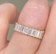 Statement Eternity Ring in Gold Minimalist band * Eternity Band * Emerald cut Engagement Ring * Wedding Ring * Bold Stacking Ring ITEM DETAILS ✦ Stone Shape:  Baguette and Round cut ✦ Total Carat (TCW) : Appx 4.0 Carats ✦ Stone Size:  - ✦ Mohs Scale :- Moissanite 9.25 ✦ Stone Type: Simulated Diamond | Moissanite ✦ Stone Color : D Color ✦ Stone Clarity: VVS1 ✦ Metal: 925 Silver , 10KT/14KT/18KT Solid Gold ✦ Metal Color: White, Rose Gold, Gold RING SIZE ✦ Choose your ring size while ordering. If the ring size is not listed in the option, then please contact us. Engraving ✦ Engraving is Available for an additional fee. OUR VALUES ✦ Designing and making jewelry is my life's passion. And there is nothing more exciting than a new great idea, so hit me with any design and style you love and I wil Stackable Emerald Cut Eternity Band For Promise Ring, White Gold Emerald-cut Stackable Eternity Band, White Gold Emerald Cut Stackable Eternity Band, Classic Stackable Emerald Cut Eternity Band, Baguette Cut Half Eternity Band, Stackable Emerald Cut Eternity Band For Anniversary, Emerald Cut Stackable Eternity Band For Wedding, Emerald Cut Engagement Ring, Mohs Scale