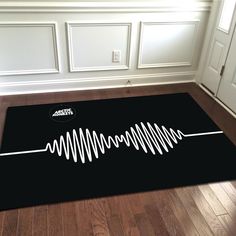 a black area rug with white sound waves on it in front of a door way