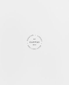 a white wall with a black and white logo on the bottom right corner that says canvas