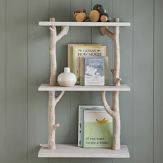 two white shelves with books and toys on them