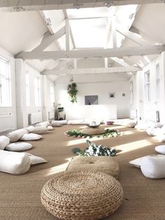 a large room with lots of pillows on the floor