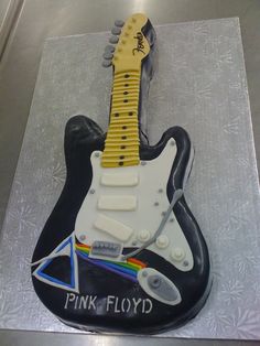 a cake shaped like a guitar with the words pink floyd on it's body