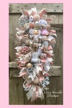 a wreath made out of seashells and ribbons