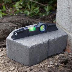 a pair of scissors sitting on top of a cement block