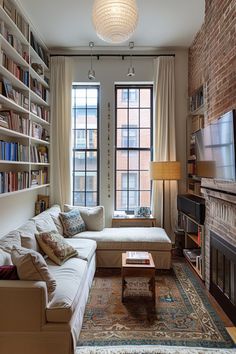 a living room filled with furniture and a fire place in front of a large window