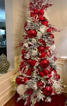 a christmas tree decorated with red and silver ornaments