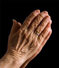 an old woman's hand holding her hands together