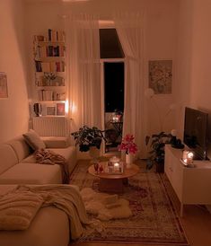 a living room filled with furniture and candles