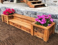 two wooden planters with pink flowers in them