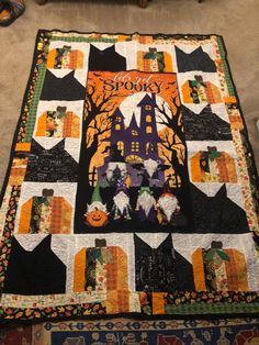 a quilted table runner with cats and pumpkins on it, in the shape of a castle