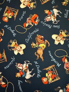 a close up of a blue fabric with cartoon characters and words written on the side