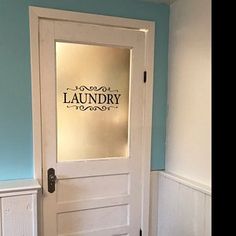 a white door with the words laundry on it in front of a blue and white wall