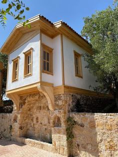 a small house built into the side of a stone wall