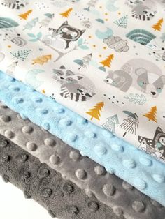 three different types of baby blankets stacked on top of each other in various colors and patterns