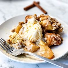 a close up of a plate of food with ice cream and cinnamon sticks in the background