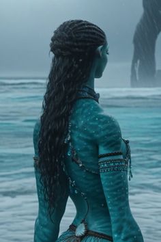 a woman with long hair standing in the water