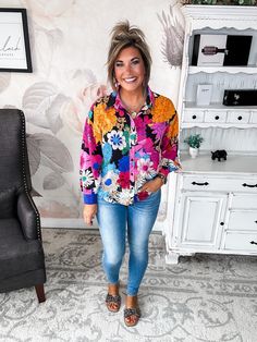 This floral blouse is ready to brighten your day and your wardrobe. Bursting with a colorful collage of flowers and geometric shapes, its lightweight woven fabric and ruched shoulders make it perfect for tropical destinations or just dreaming of them. Flirty shirring details and a button front add feminine flair, while its collared neckline maintains a polished profile. Equal parts playful and posh, this top is ideal for both work and weekend. Slip it on with crisp trousers or your favorite dist Colorful Floral Print Long Sleeve Tops, Casual Colorful Floral Print Tops, Colorful Long Sleeve Blouse For The Beach, Colorful Long Sleeve Blouse For Beach, Colorful Long Sleeve Beach Blouse, Casual Floral Patchwork Blouse For Fall, Vibrant Floral Print Blouse For Vacation, Fall Multicolor Floral Print Tops, Vibrant Floral Print Beach Blouse