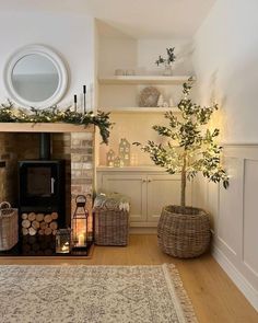 a living room filled with furniture and a fire place covered in greenery next to a fireplace