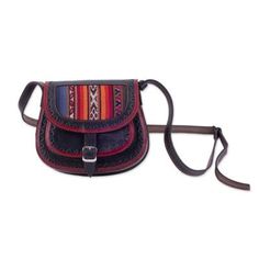 Designed by Kathiana Quispe this Peruvian sling makes an excellent companion on your journeys. It is handcrafted of leather in black and red with Inca-style embossed designs resembling a saddle bag that drapes over the shoulder on an adjustable strap. A colorful wool panel accents the front flap which opens with a buckle to reveal a small pocket in front of a larger main compartment. Traditional Leather Saddle Bag, Traditional Leather Saddle Bag With Adjustable Strap, Artisan Black Crossbody Shoulder Bag, Red Leather Festival Bag, Black Artisan Hand-tooled Bag, Black Hand Tooled Artisan Bag, Artisan Hand Tooled Black Bag, Artisan Black Hand-tooled Bag, Artisan Hand-tooled Black Bag