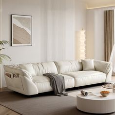 a living room filled with white furniture and a large painting on the wall behind it