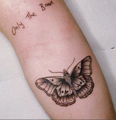 a small butterfly tattoo on the left forearm and right arm, with only the brave written in cursive ink