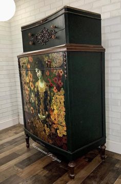 an ornate painted chest on wooden floors in front of a white brick wall and wood flooring