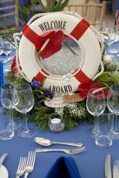 there is a welcome aboard sign on the table with silverware and wineglasses