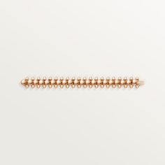 a gold beaded bracelet on a white background