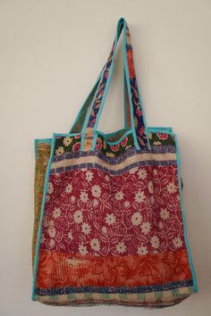 This bag is made from a vintage hand-stitched Kantha quilt. We make only 1-2 bags from each quilt and every one of them is one of a kind! Details: Shell fabric- Vintage Quilted Cotton Kantha 1. width (cm) - 40 2. height (cm)- 45 3. depth (cm) - 45 4. weight (g)- 0.400 kg 5. length of the shoulder (cm) -40 cm Care instructions: Dry clean or Hand-wash in warm water. Drip dry. How it's made: Kantha quilts are made using numerous layers of recycled silk or cotton saris which are hand-stitched in the traditional Bengal style called Kantha. What originated as a cost-effective way to produce warm blankets has developed over the years into a beautiful art form, creating truly unique of kind designs. Red Patchwork Tote Shoulder Bag, Vintage Multicolor Bags For Daily Use, Travel Tote Bag With Patchwork, Vintage Multicolor Patchwork Bag, Patchwork Tote Bag For Shopping, Patchwork Tote Shopping Bag, Bohemian Reversible Rectangular Shoulder Bag, Rectangular Patchwork Shoulder Bag For Shopping, Patchwork Shoulder Bag For Shopping