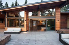 a modern house with wood siding and glass doors