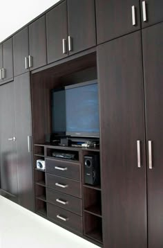 an entertainment center with cabinets and a television