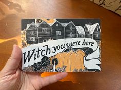 a hand holding up a card that says, witch you're here with an image of a pumpkin on it