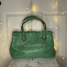 This Is A Green Purse In Perfect Condition!! Only Used A Couple Of Times! 1 Exterior Zip Pocket, 1 Large Dividing Zip Pocket In The Middle, 1 Small Zip Pocket And 2 Small Slip Pockets All On The Inside. It Has 2 Large Compartments. Silver Hardware And Comes With Dust Bag! W 13 1/2 In/ H 10in/ D 4in And Handle Is 8in From Top Coach Crossbody Purse, Tan Handbags, Green Purse, Buckle Bags, Bags Coach, Brown Purses, Coach Shoulder Bag, Black Leather Purse, Black Leather Tote