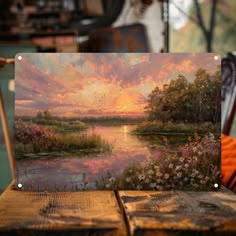 a painting of a sunset over a lake