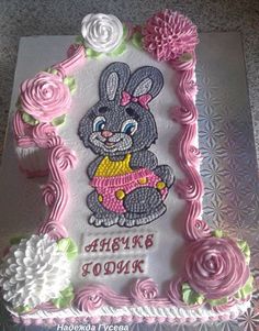 a birthday cake decorated with pink frosting and an image of a bunny