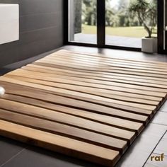 a bathroom with a large wooden mat on the floor and a white toilet in the background