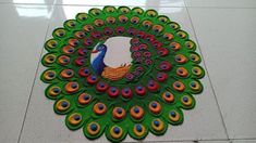 there is a peacock made out of cupcakes on the floor