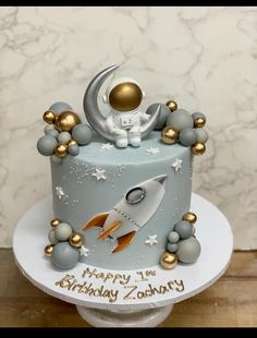 a birthday cake with an astronaut on top