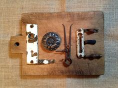 an assortment of old fashioned kitchen utensils on a cutting board with handles and knobs