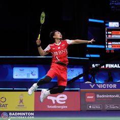 a man jumping in the air while holding a tennis racquet